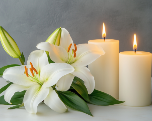 White lilies and lit candles symbolizing remembrance and loss, representing wrongful death cases in Dallas and the role of expert witnesses in proving damages and liability.